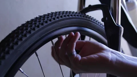 Man inflates a bicycle wheel Stock Footage