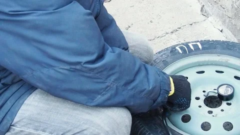 Man inflates car tyre pump Stock Footage 108112360