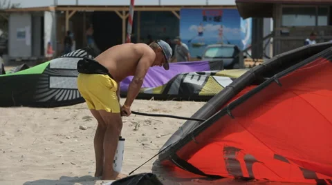Man Inflating Wing Kite by Pump Stock Footage 59156708