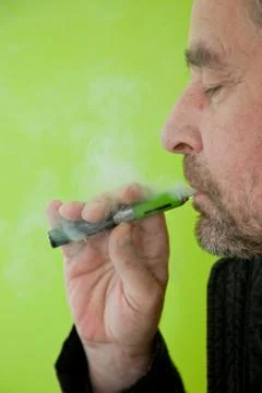 Man inhaling from an electronic cigarette Stock Photos