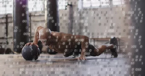 Man initiating routine by lowering chest, doing med ball pushups for fitness, Stock Footage 330676135