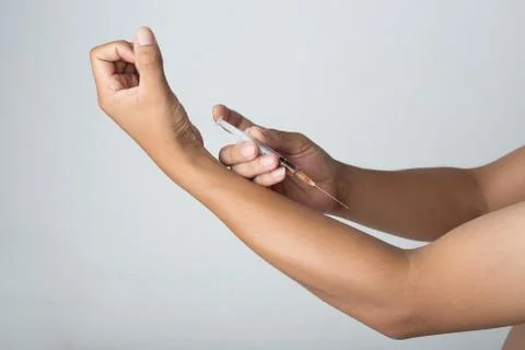 Man Injected into the arm Stock Photos