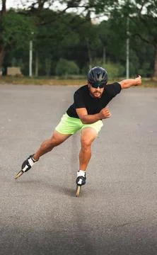 Man inline skating outdoors performing exercise activity Stock Photos