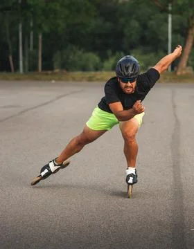Man inline skating for speed and fitness outdoors Stock Photos
