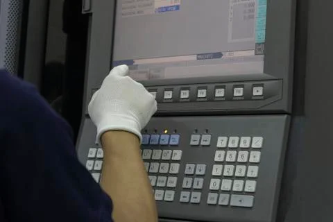 Man input data on cnc machine panel control Stock Photos