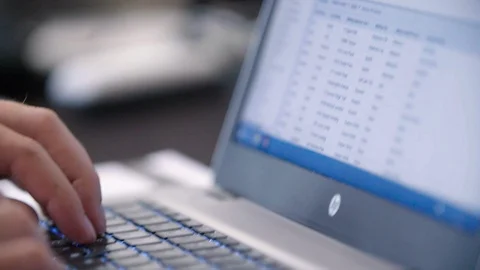 Man inputing data into a laptop, close up Stock Footage 92178681
