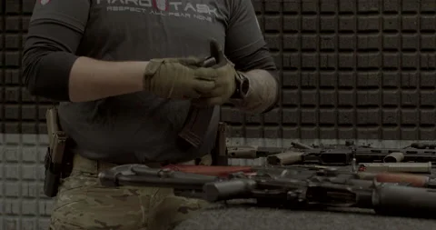 Man insert cartridge armor-piercing bullet, automatic weapon detachable magazine Stock Footage 182375055