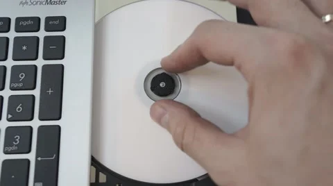 Man insert disk in laptop Stock Footage 47476755