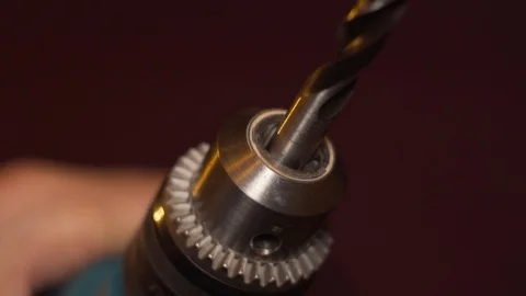 Man inserting and tightening a drill bit in an electric drill, close-up shot. Stock Footage 100107861