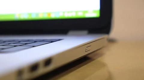 Man Inserting CD - DVD Drive of Laptop or Notebook  Stock Footage 52910410