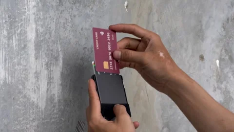 Man Inserting Credit Card into Minimalist Aluminum RFID Wallet Stock Footage 343136586