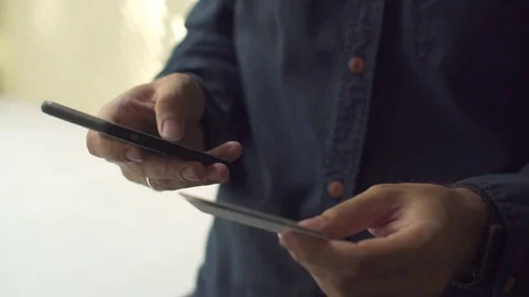 Man inserting credit card number on mobile phone, Online banking Stock Footage 79141518