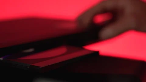 Man inserting disk into DVD player 動画素材 315019633