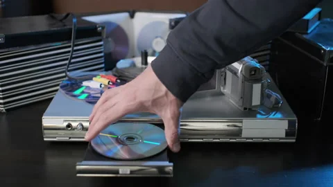 Man Inserting DVD Disc to Video Player Stock Footage 170185634