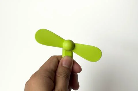 A man is inserting a green mini fan to a power bank Fotos de archivo