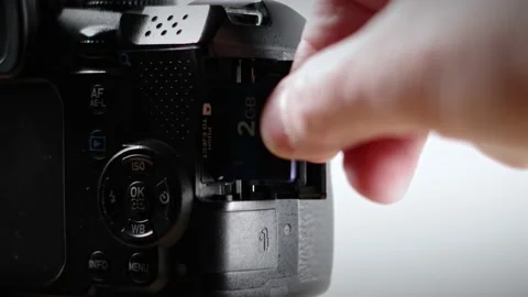 A Man Inserting an SD Card into a Digital Camera - 4K Stock Footage 171261754