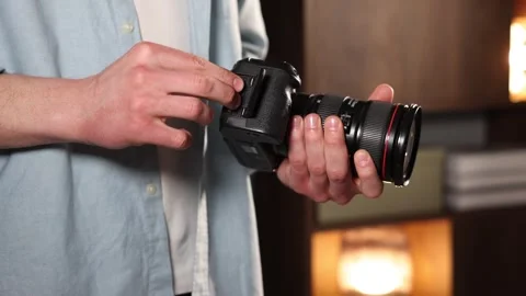 Man inserting SD memory card into photo camera indoors, closeup Stock Footage 305855982