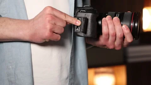 Man inserting SD memory card into photo camera indoors, closeup Stock Footage 305929025
