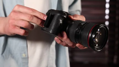 Man inserting SD memory card into photo camera indoors, closeup Stock Footage 306178886