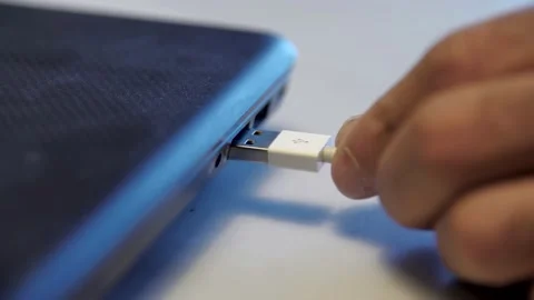 Man inserting usb cable into laptop. Media. Close up of male hand сonnecting Stock Footage 142929039