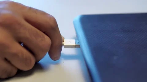 Man inserting usb cable into laptop. Media. Close up of male hand сonnecting Stock Footage 143069853