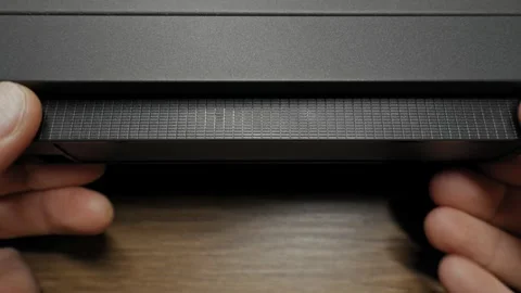 Man Inserting A VHS Video Cassette Tape Into A Vintage VCR Player Vídeos de archivo 330298557