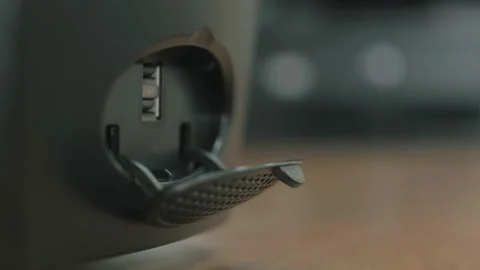 Man inserting a white cable into the USB socket of a computer, which is on the Stock Footage 150756296