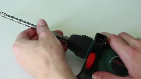 Man inserts a drill into the perforator Vídeos de archivo 65371021