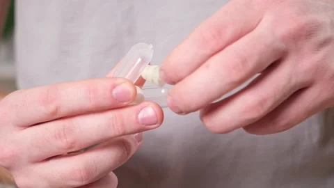 Man inserts earplugs so as not hear extraneous noise, music, snoring. Silicone Stock Footage 237858602
