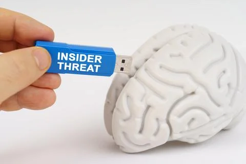 A man inserts a flash drive into his brain with the inscription - INSIDER T.. Stock Photos