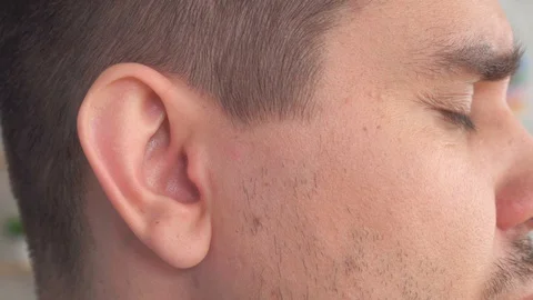 Man inserts a hearing aid into her ear close up Stock Footage 112245191