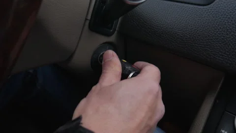 Man inserts the ignition key and starts the car. 4K resolution Stock Footage 250406845