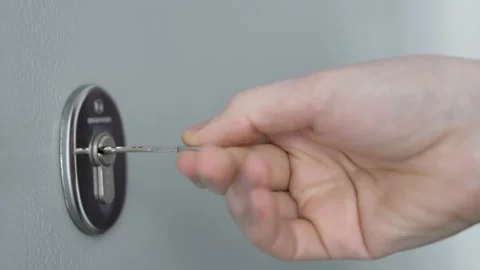 The Man Inserts The Key into The Door Lock and Turns the Key, Macro. Close-up of Stock Footage 151251432