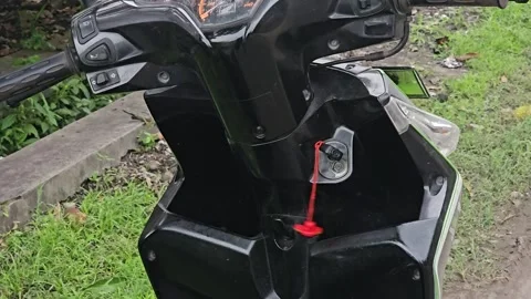 Man Inserts Key Into Ignition Of Black Scooter And Prepares To Ride Stock Footage 345327999