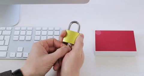 The man inserts the key into the lock and opens it in his hand. Stock Footage 148381546