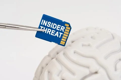 A man inserts a memory card into his brain with the inscription - INSIDER T.. Stock Photos
