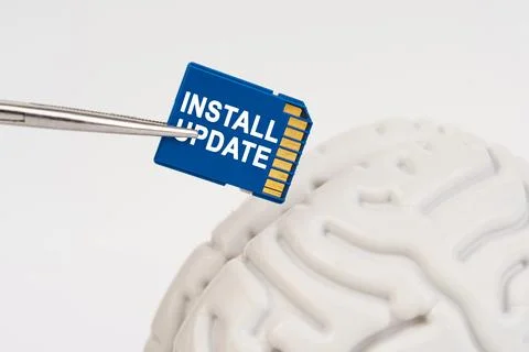 A man inserts a memory card into his brain with the inscription - Install U.. 写真素材