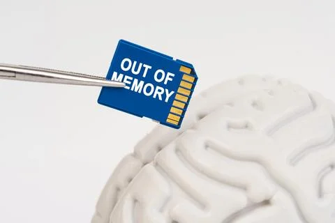 A man inserts a memory card into his brain with the inscription - Out Of Memo 写真素材