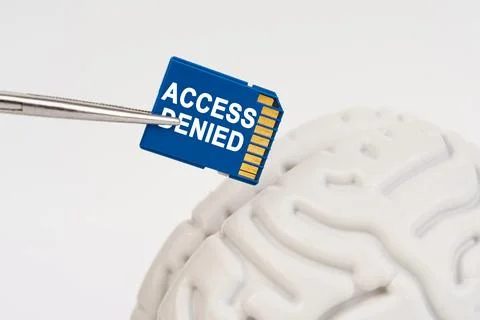 A man inserts a memory card into his brain with the inscription - access deni Stock Photos