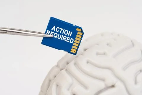 A man inserts a memory card into his brain with the inscription - Action Re.. Stock Photos
