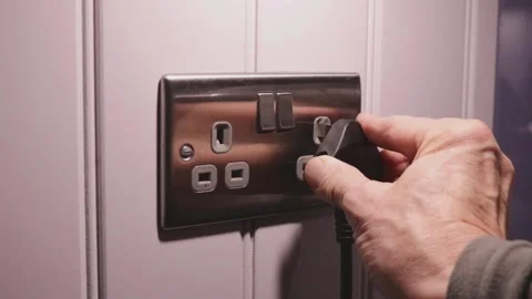 Man Inserts Plug in Socket and Flicks Switch Stock Footage 250007237
