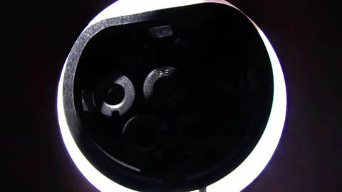 Man inserts a power cord into an electric car for charging Vidéo 188511169