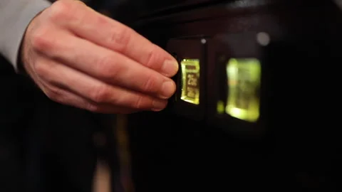 A man inserts quarters into an arcade game to play. Stock Footage 147969461