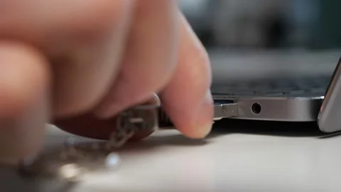 Man inserts USB device into port connecting to laptop Video stock 172424899