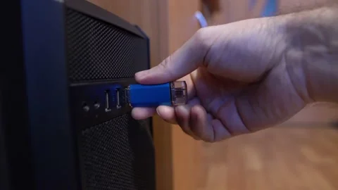 Man inserts a USB flash drive from a computer connector Stock Footage 144099248