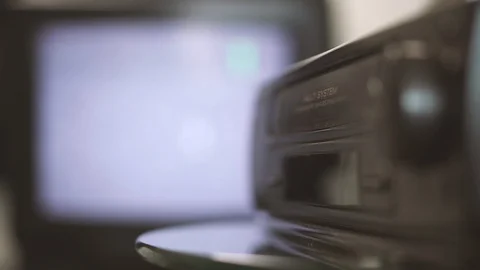 A man inserts a video cassette into a VCR. Hand close-up Stock Footage 114504442