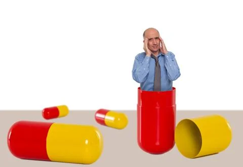 Man inside a capsule not feeling well Stock Photos