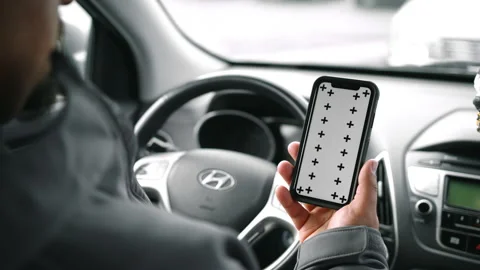 Man Inside Car Looking At Phone With Tracking Markers Stock Footage 166522883