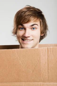 Man inside a card box Stock Photos