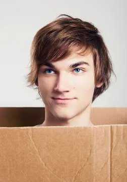 Man inside a card box Stock Photos